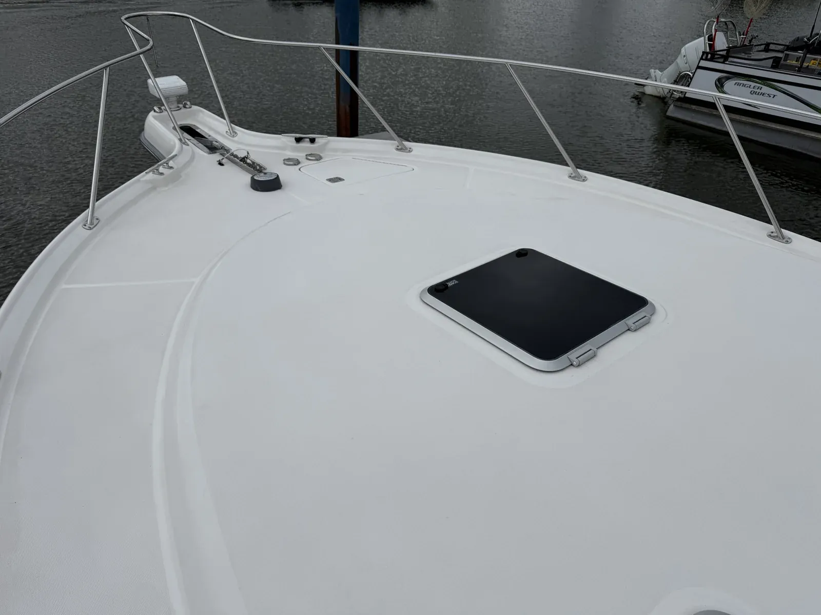 Clean white boat bow deck and hatch after an on-deck cleaning