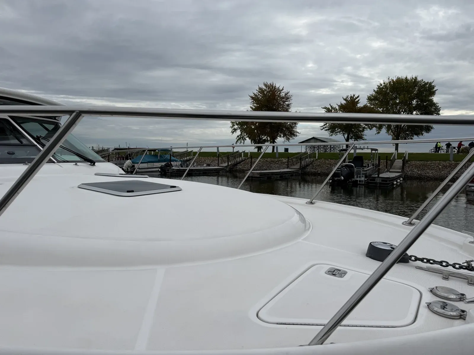 White cruiser bow deck and stainless rails after boat detailing at the marina