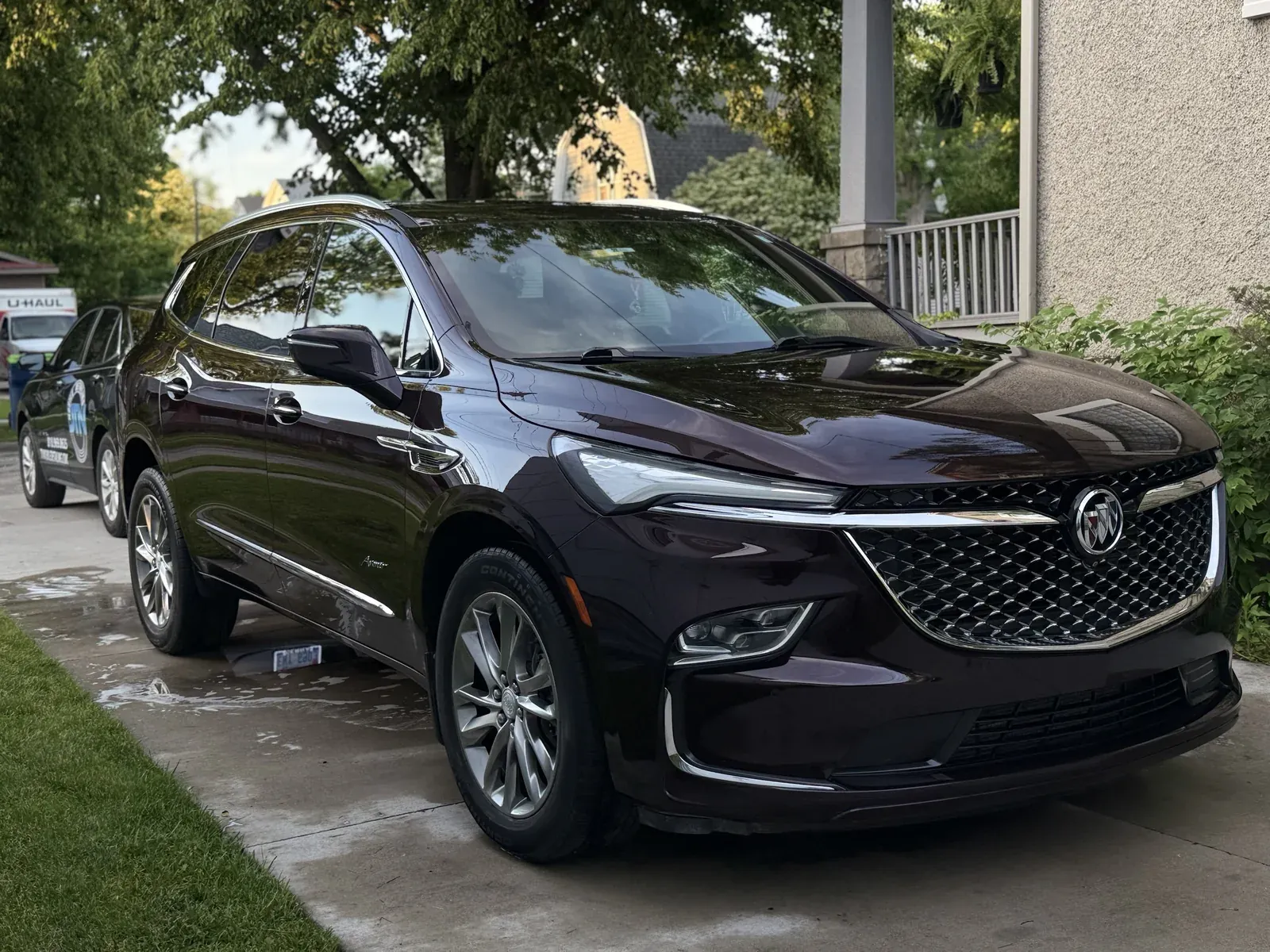 Dark Buick Enclave Avenir after a mobile detail, JTN unit parked behind