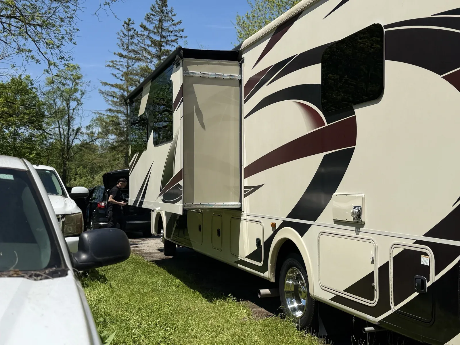 Class A motorhome with slide-out extended during an on-site mobile RV detail