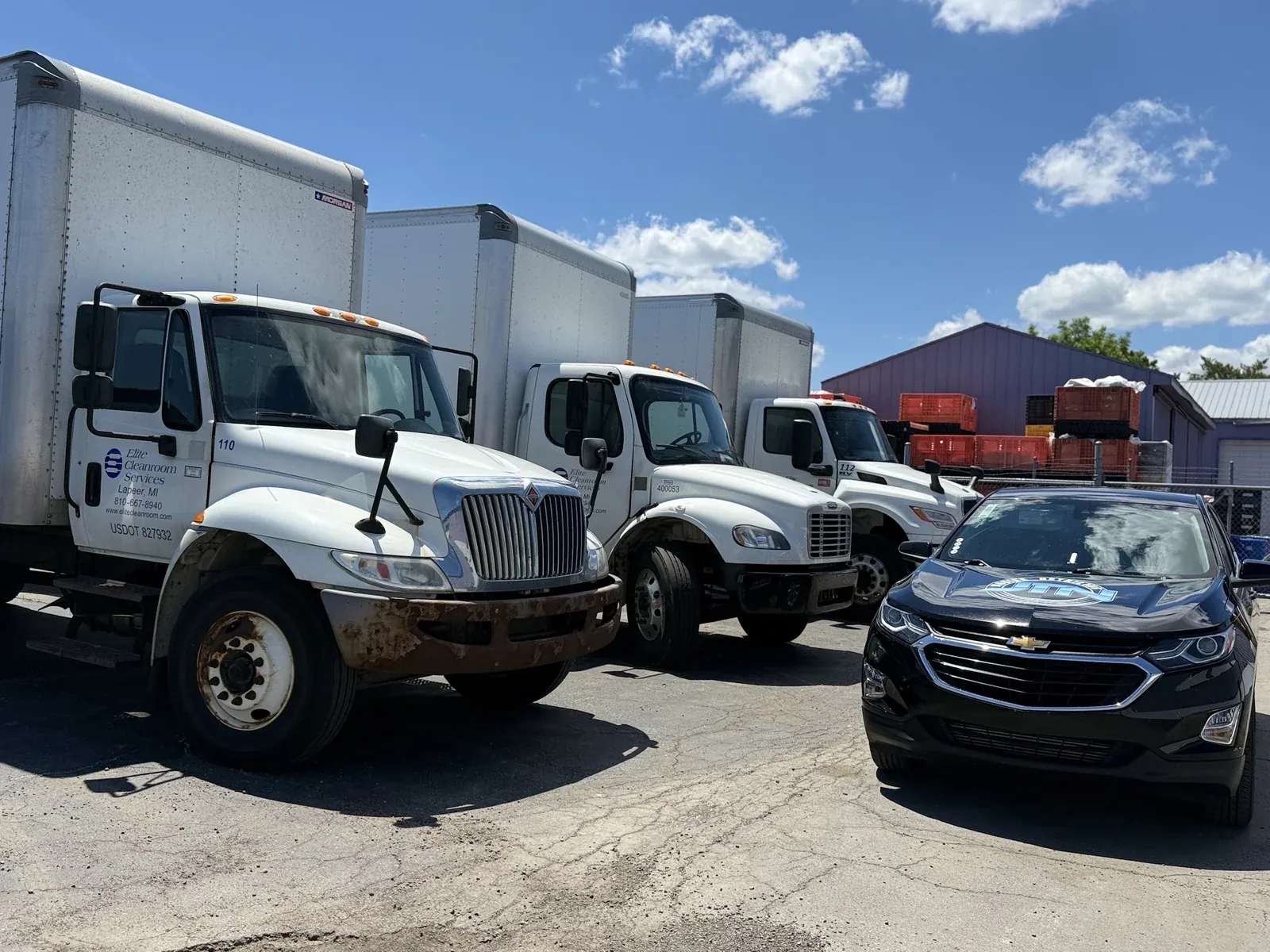 Fleet box trucks at a business lot with a JTN Mobile Detailing unit on site