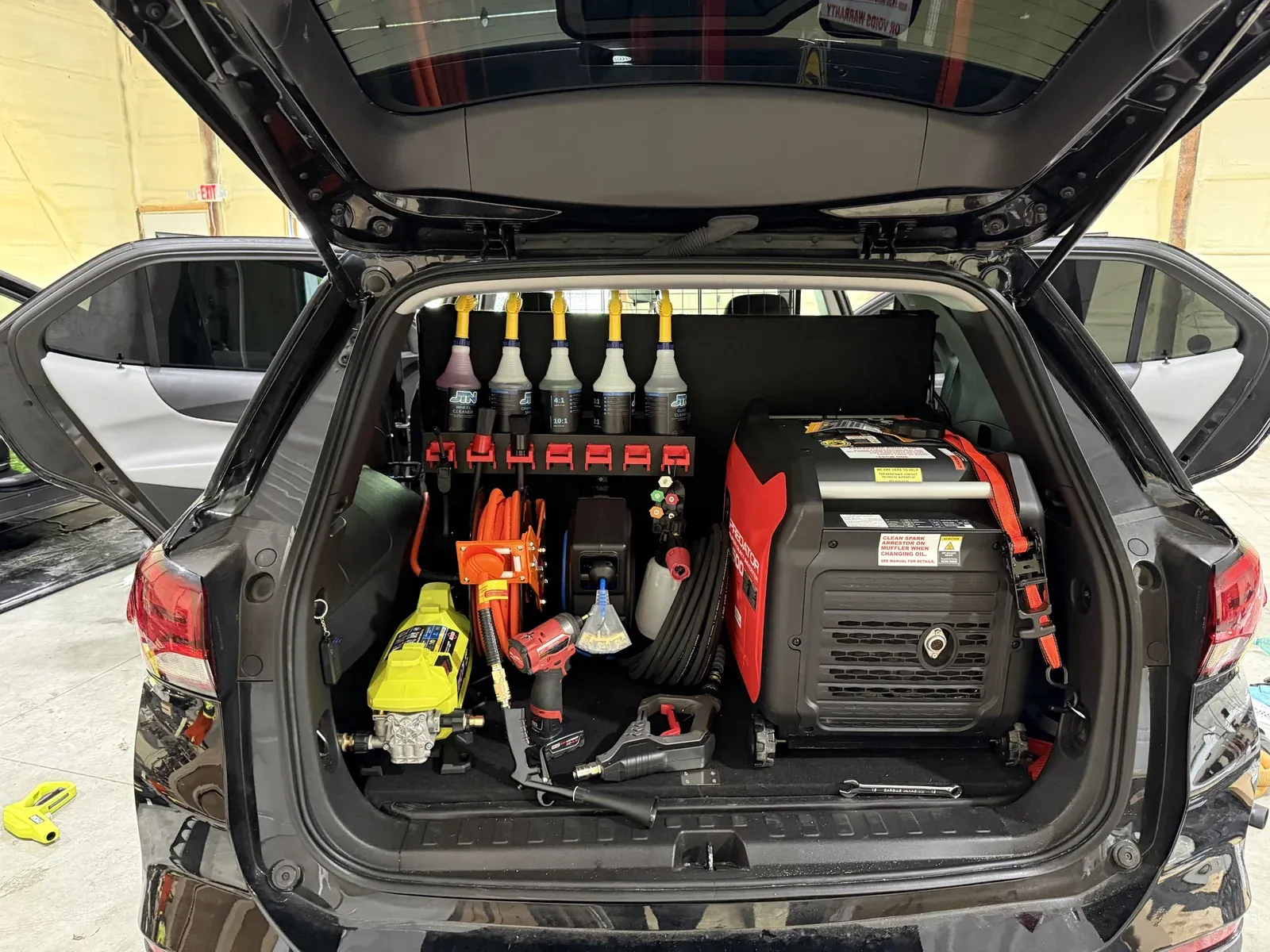 Inside a JTN Equinox mobile unit: generator, pressure washer, hose reel and JTN detailing products