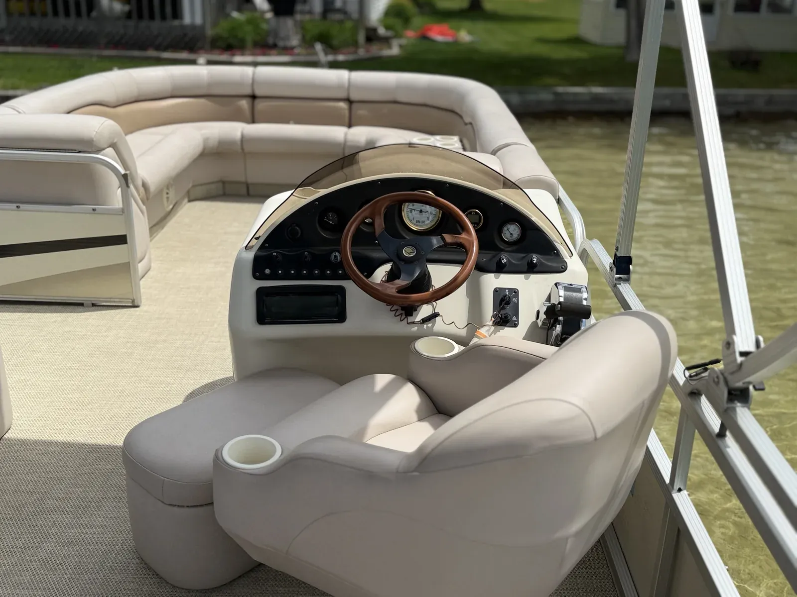 Pontoon boat helm, captain's chair and lounge seating after an on-deck clean
