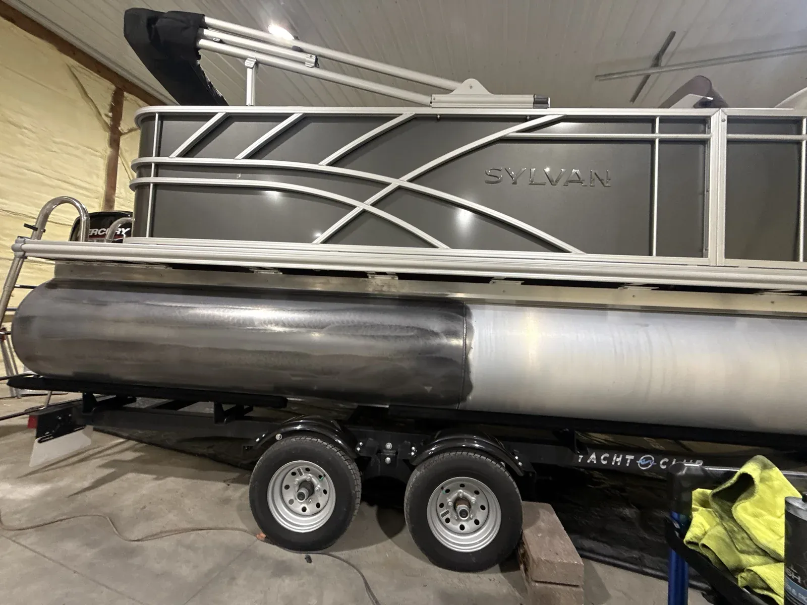 Sylvan pontoon tube half polished, showing oxidized vs. restored aluminum